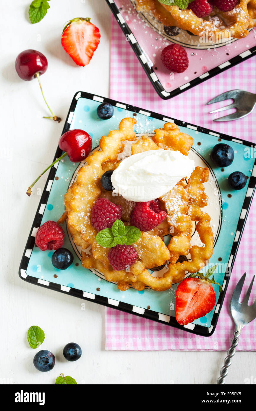 Funnel cakes with fresh berries and whipped cream Stock Photo