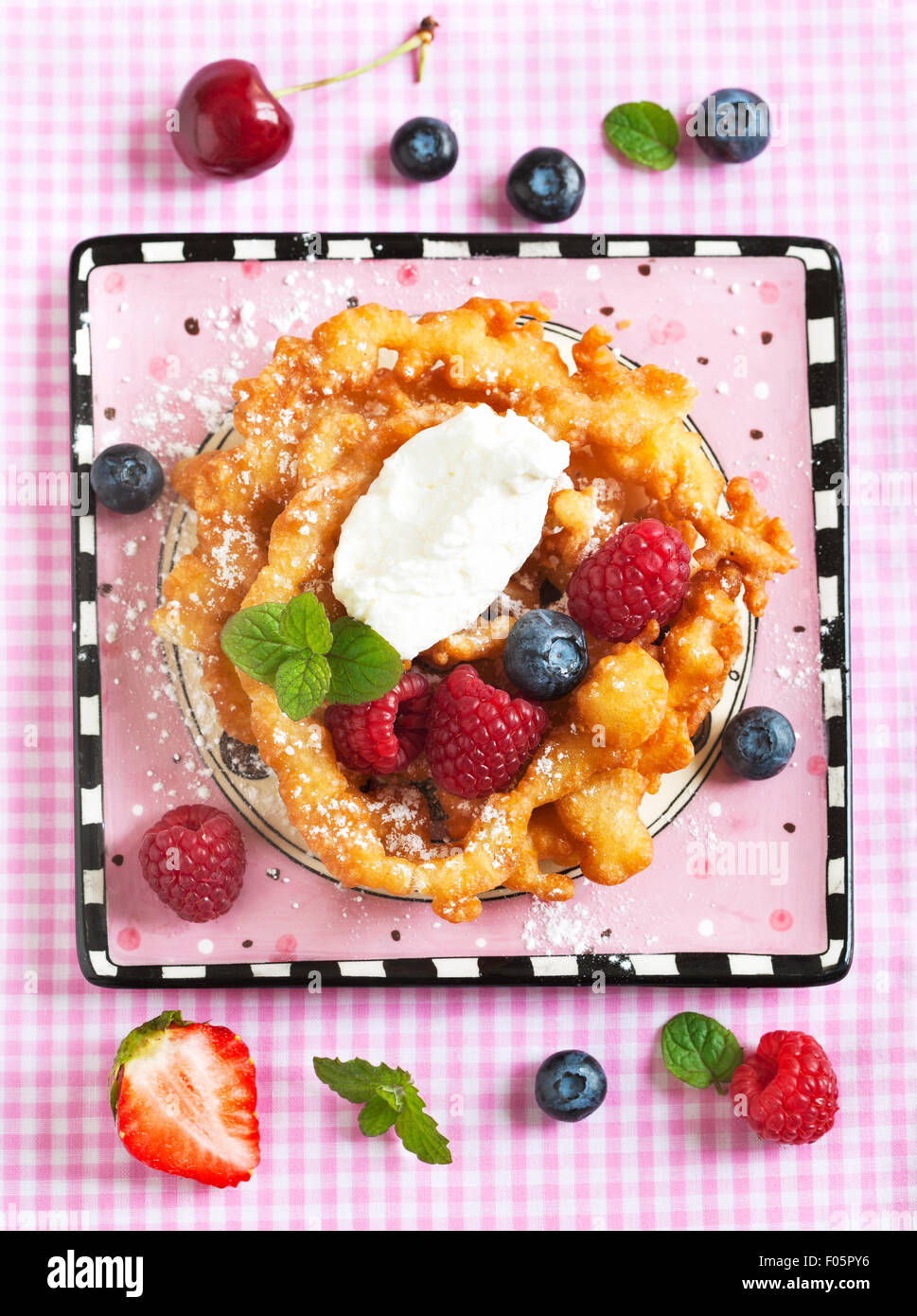 Funnel cakes with fresh berries and whipped cream Stock Photo Alamy
