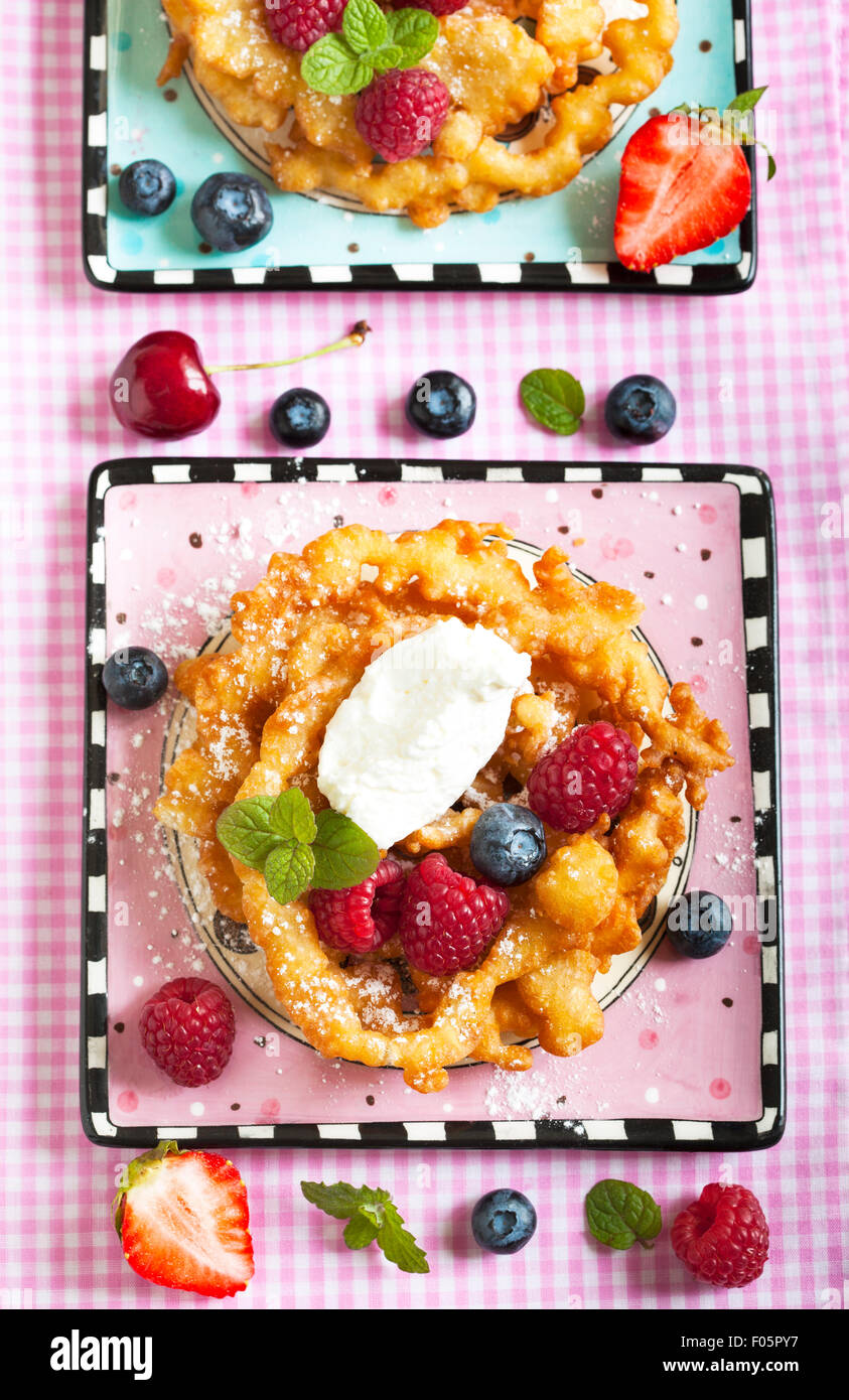 Funnel cakes with fresh berries and whipped cream Stock Photo