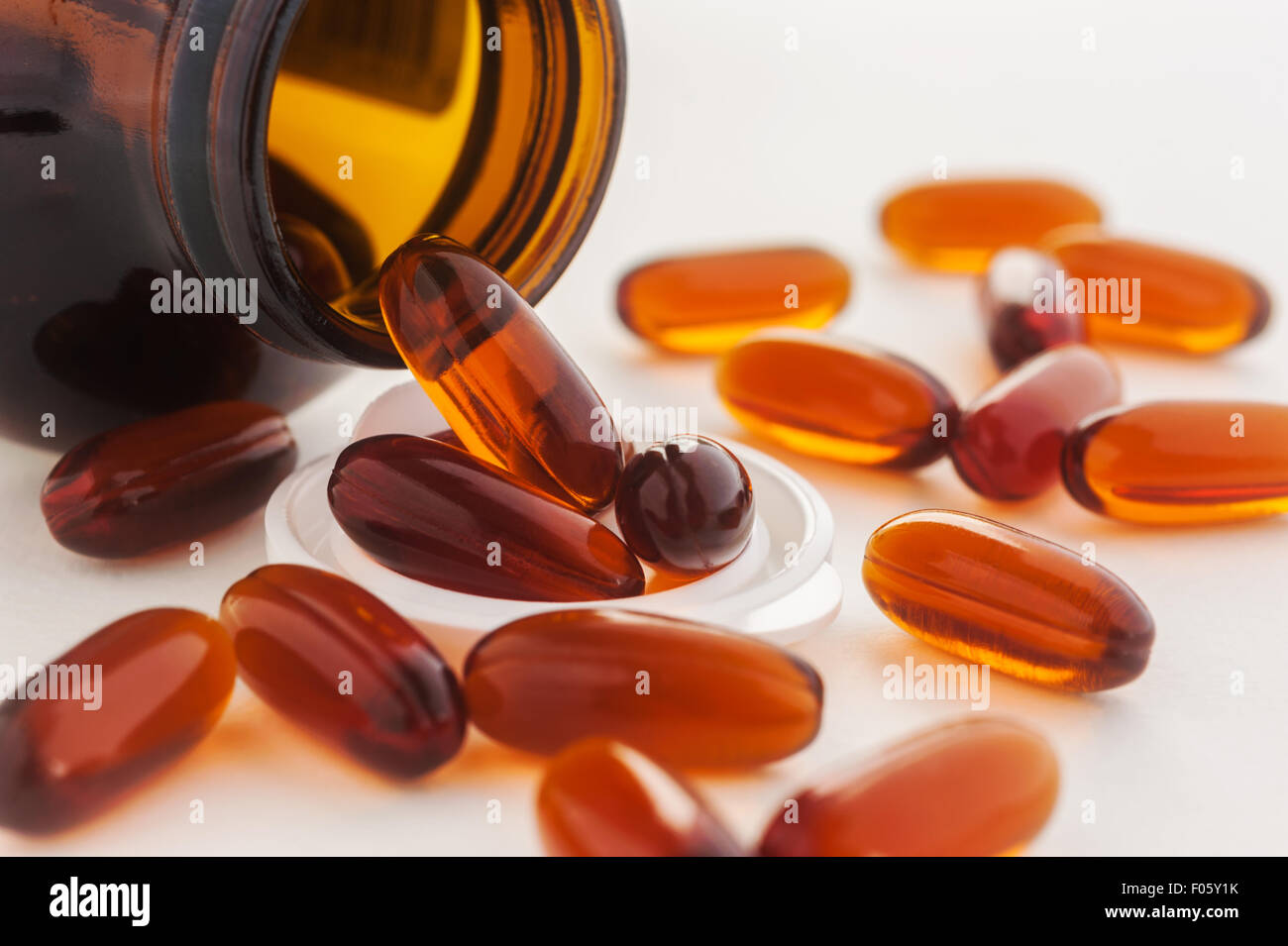 Vitamin in capsule spilling out of a bottle, Selective focus Stock Photo