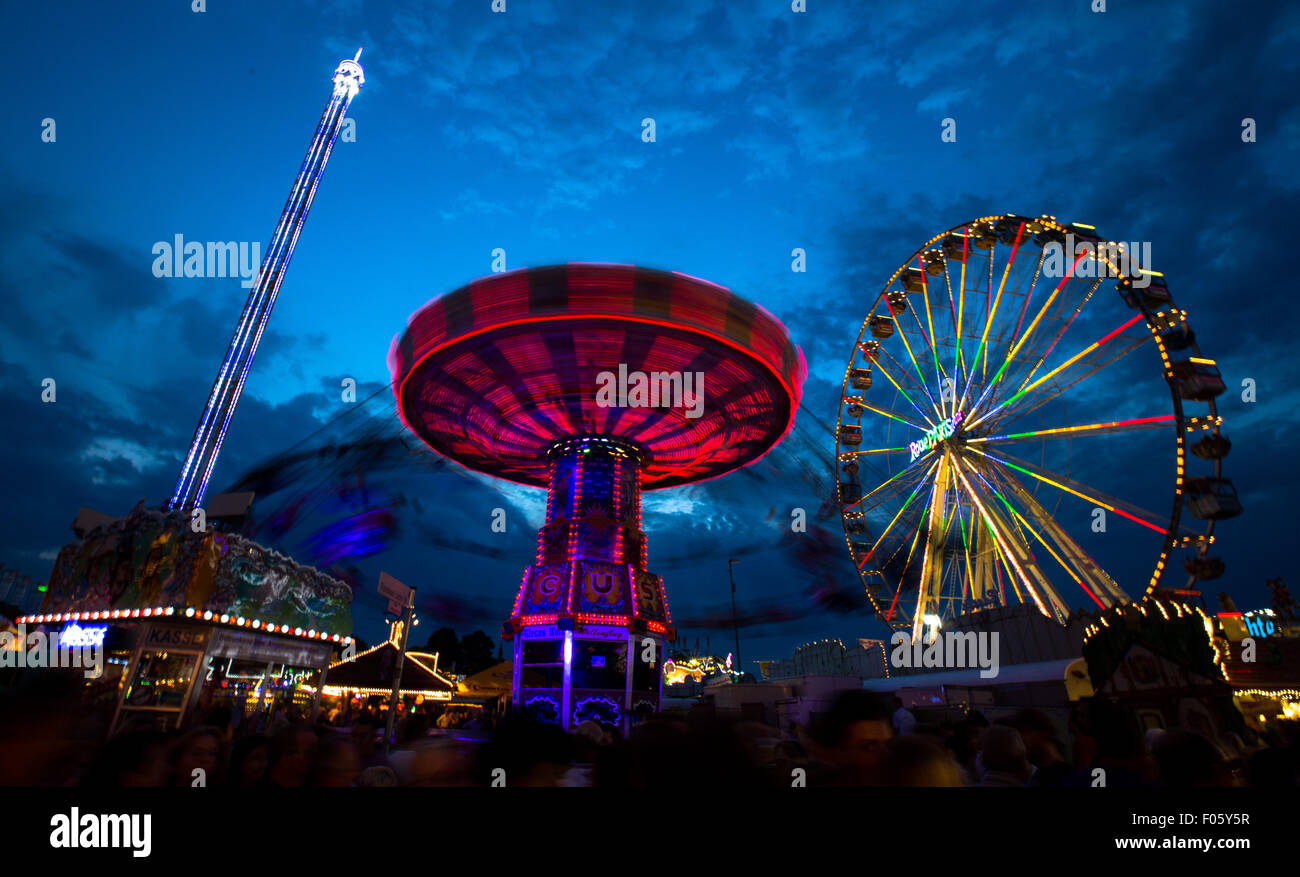 Herne, Germany. 7th Aug, 2015. Visits meander through the illuminated grounds of the Cranger Fun Fair in Herne, Germany, 7 August 2015. Around 4 million visitors attend Germany's second largest folk festival every year. Photo: Marcel Kusch/dpa/Alamy Live News Stock Photo