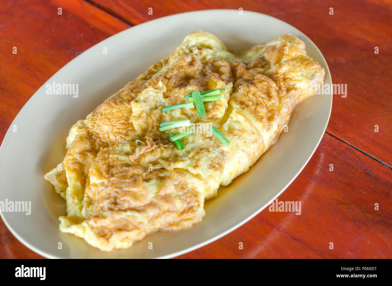 Thai omelette  or scrambled eggs with spring onion on dish Stock Photo