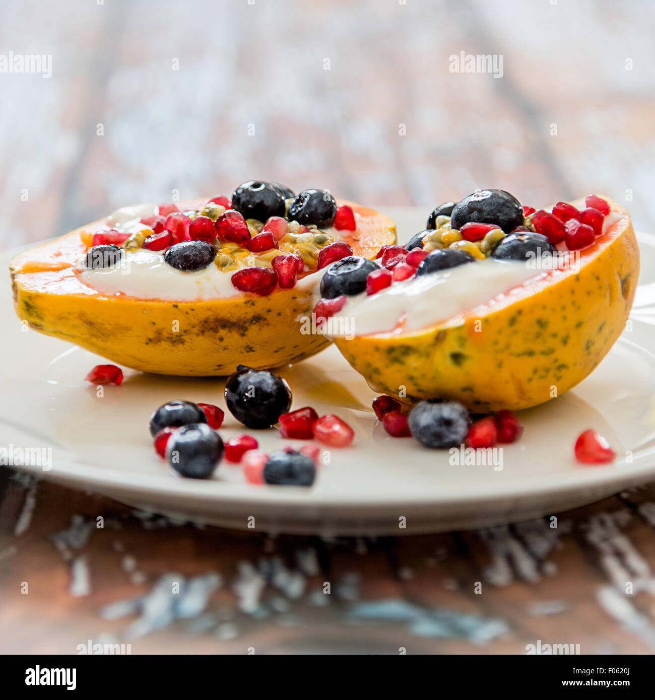 papaya with natural soy yogurt and fresh berries, light and healthy