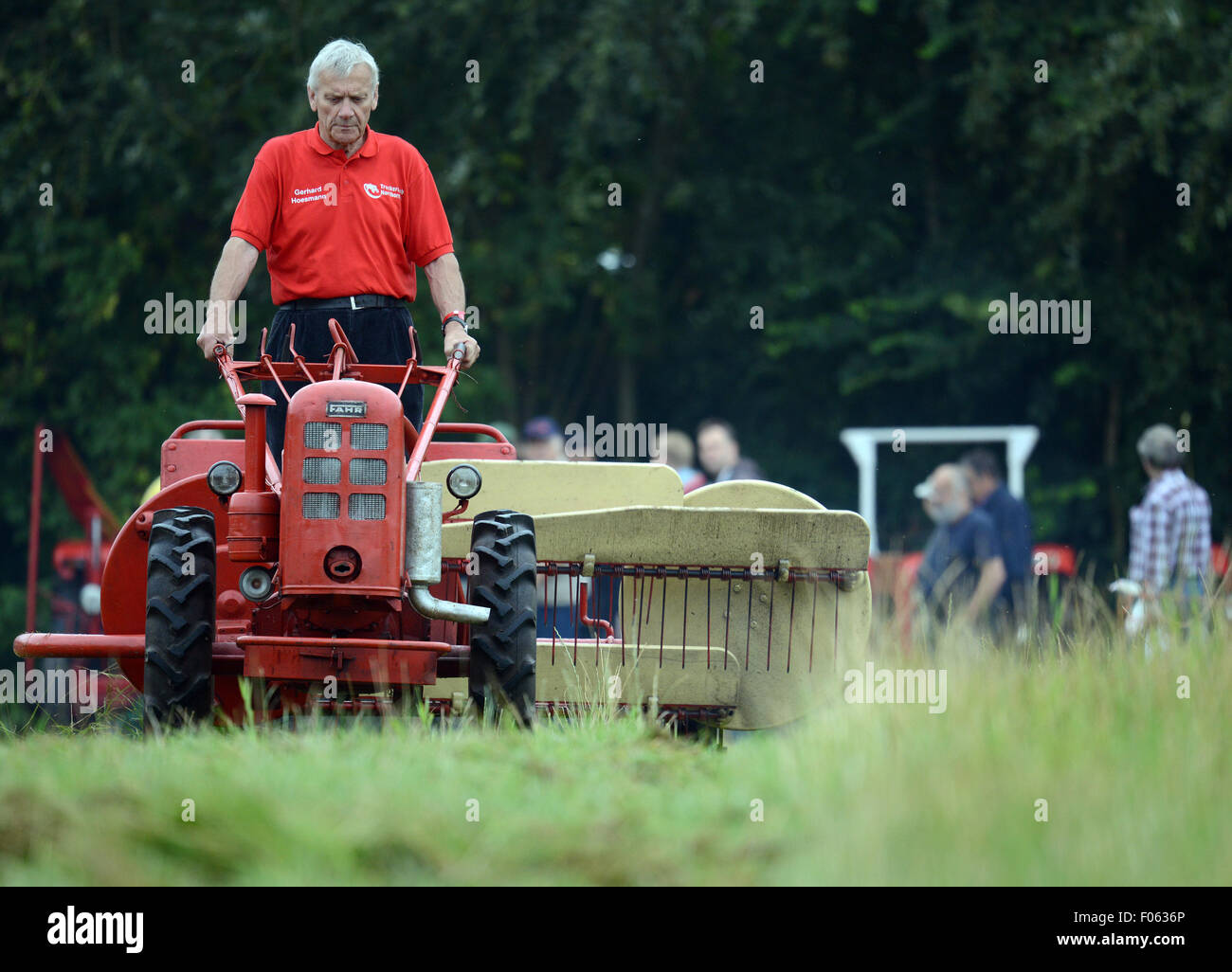 Nordhorn, Germany. 8th Aug, 2015. Gerhard Hoesmann from the Treckerclub Nordhorn on a Fahr tractor at the 23rd Historical Field Days in Nordhorn, Germany, 8 August 2015. 1600 exhibitors are expected to bring 2000 tractors to this year's agricultural machinery show, which has a special focus on machines produced by Deutz. PHOTO: CAROLINE SEIDEL/DPA/Alamy Live News Stock Photo