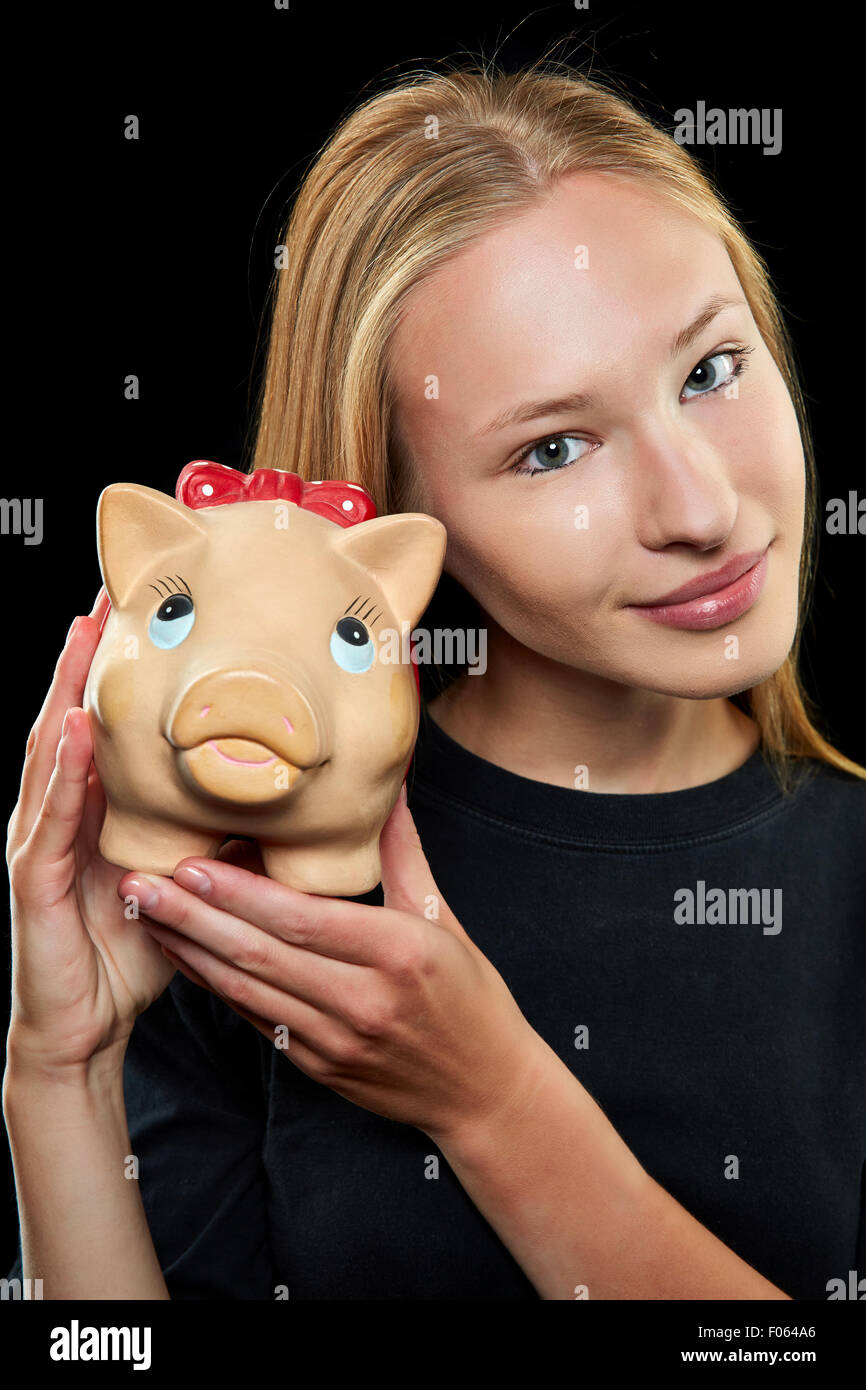 Young blonde woman holding a big piggy bank in her hands Stock Photo ...