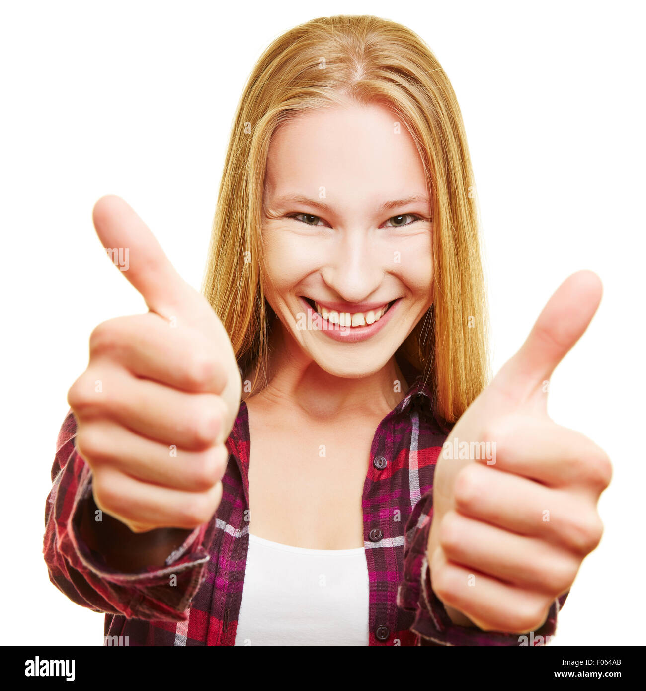 Cheering young blonde woman holding both thumbs up Stock Photo