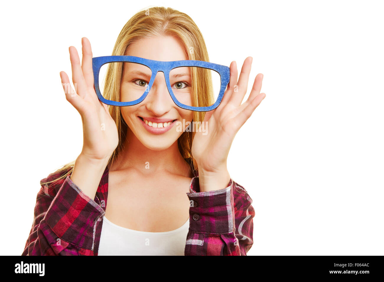 Young blonde woman holding fake nerd glasses in front of her eyes Stock Photo
