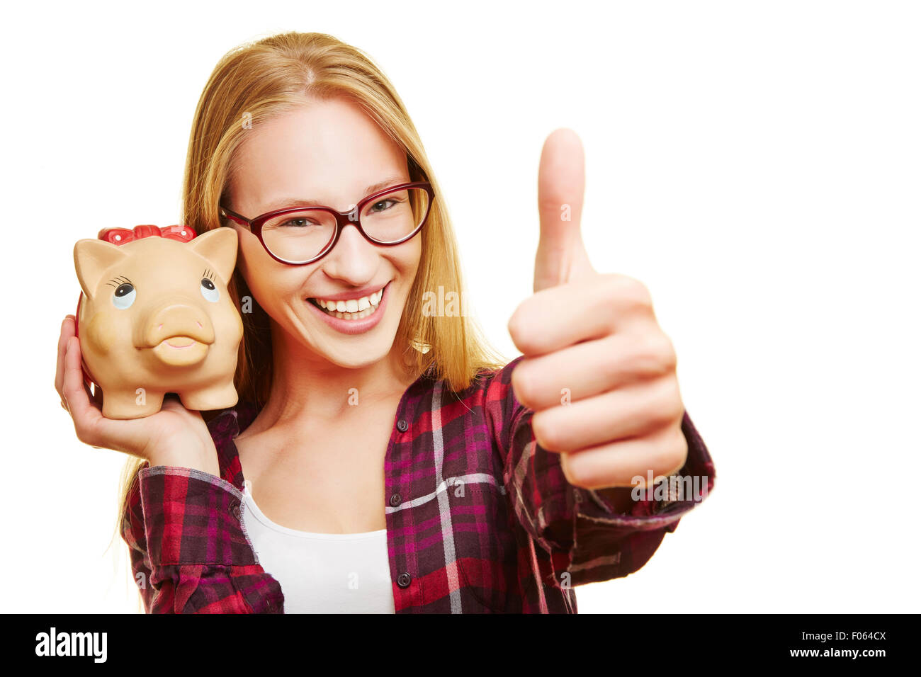 Smiling happy woman with piggy bank holding her thumbs up Stock Photo ...