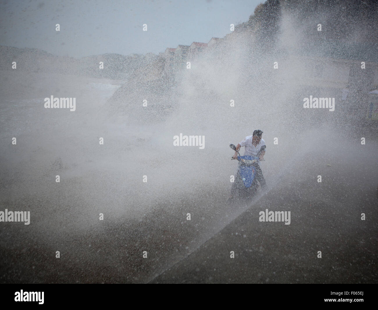 Wenling, China's Zhejiang Province. 8th Aug, 2015. Huge waves brought by super typhoon Soudelor hit a rider on the coast in Wenling City, east China's Zhejiang Province, Aug. 8, 2015. Credit:  Zhou Xuejun/Xinhua/Alamy Live News Stock Photo
