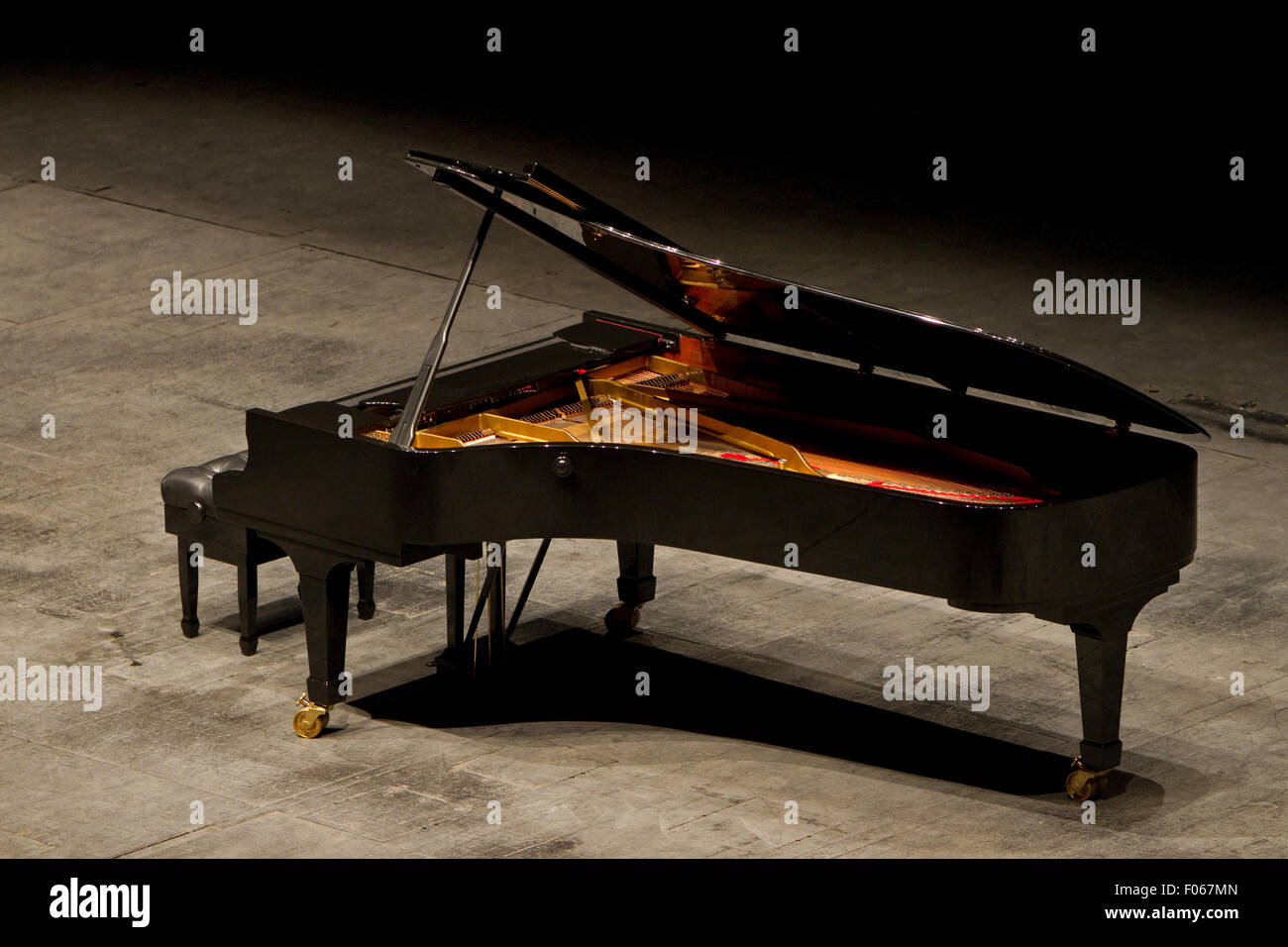 An open black grand piano on a stage Stock Photo Alamy