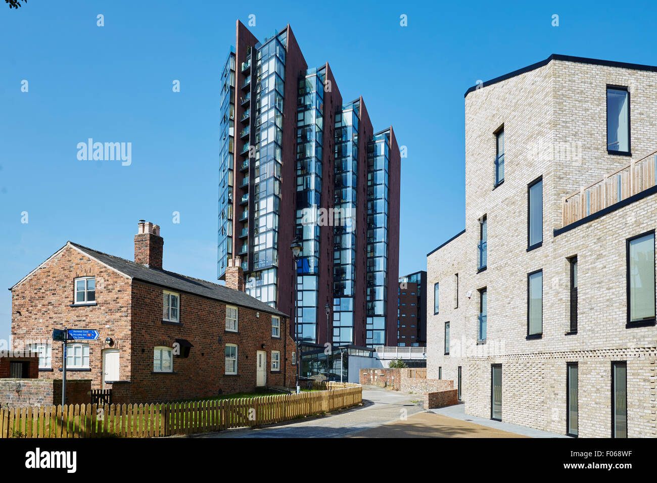 Islington Wharf in the middle with an old waterways cottage building, alongside the Ashton Canal, in New Islington, Manchester, Stock Photo