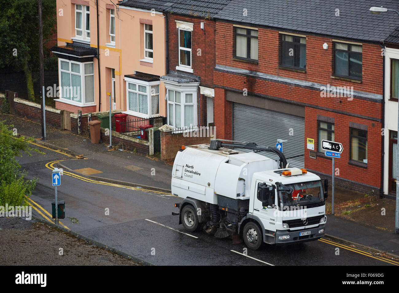 Scunthorpe tow centre street sweeper cleaning the road on a wet  terraced road   UK Great Britain British United Kingdom Europe Stock Photo