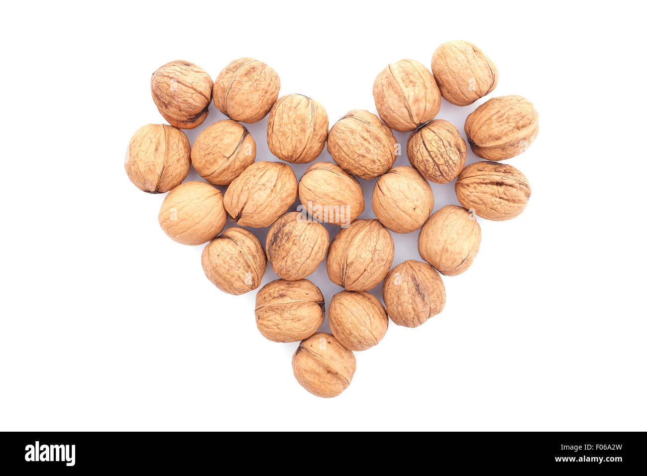 Walnuts in a heart shape, isolated on a white background Stock Photo
