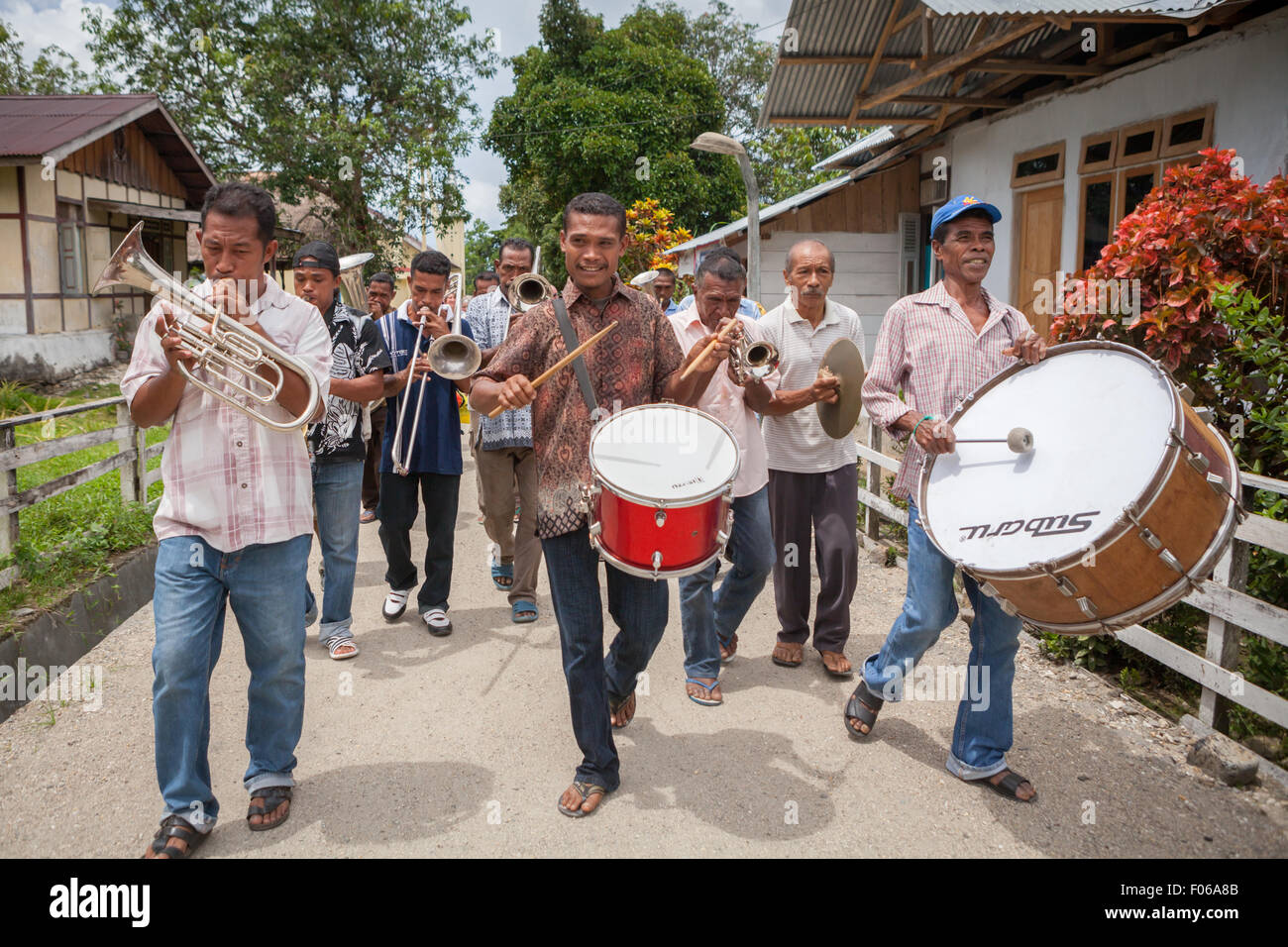Villagers playing trumpets and drums during a rural orchestra performance to welcome tourists in Rumahkay, West Seram, Maluku, Indonesia. Stock Photo