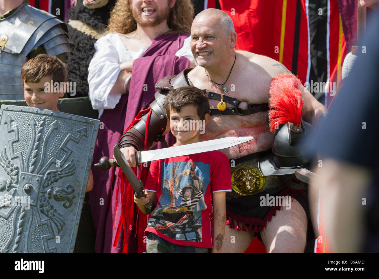 Wallsend, Tyne and Wear, UK. 8th August, 2015. Hadrian Festival at Segedunum Roman Fort: Two young boys pose with Roman Emperor Hadrian and Roman Gladiators. The Hadrian Festival is part of the programme of activities supporting the British Museum's Roman Empire: Power & People exhibition which is on public display 30 May – 13 September 2015 Credit:  Andrew Nicholson/Alamy Live News Stock Photo