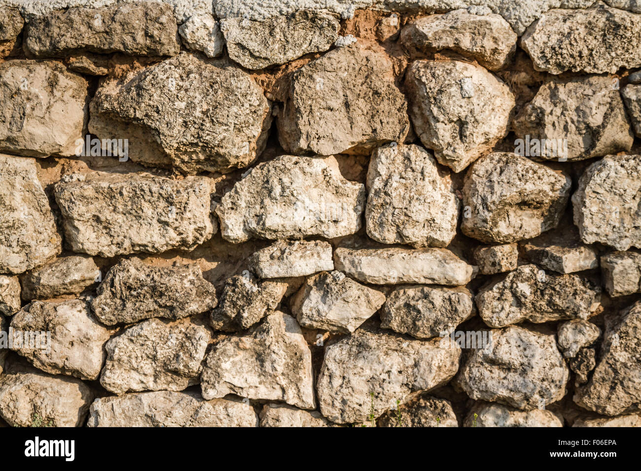 View of a natural stone wall built with clay mortar Stock Photo Alamy