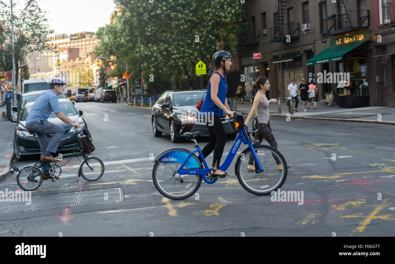 A bicycle enthusiast uses her Citibike to cross Greenwich Avenue in the