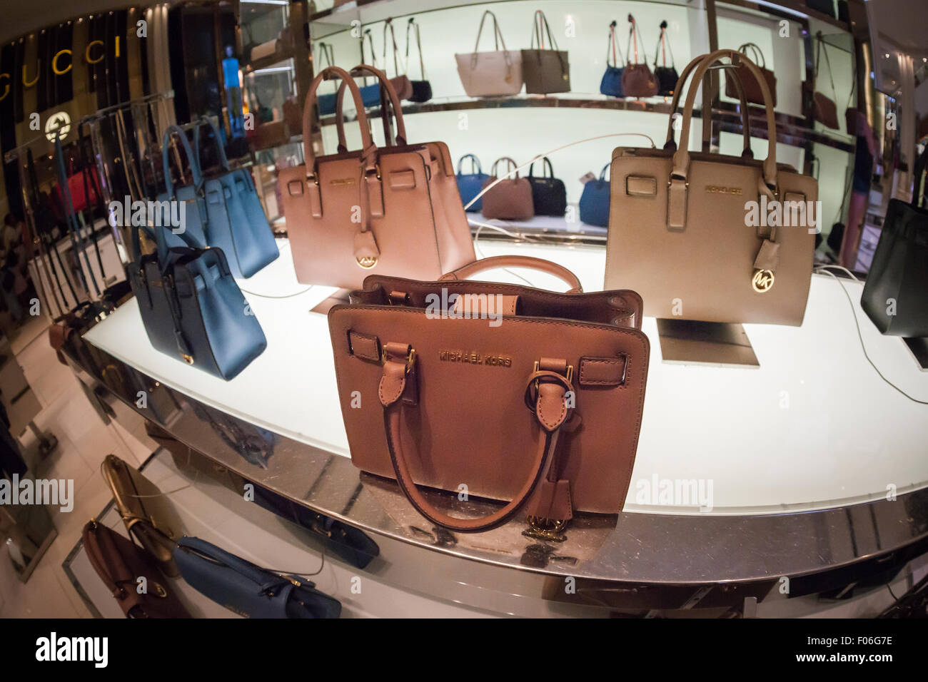 Handbags on display at the Michael Kors boutique within Macy's in New York  on Tuesday, August 4, 2015. First-quarter sales and profits for Michael Kors  handbag designer beat analysts' expectations, albeit low,