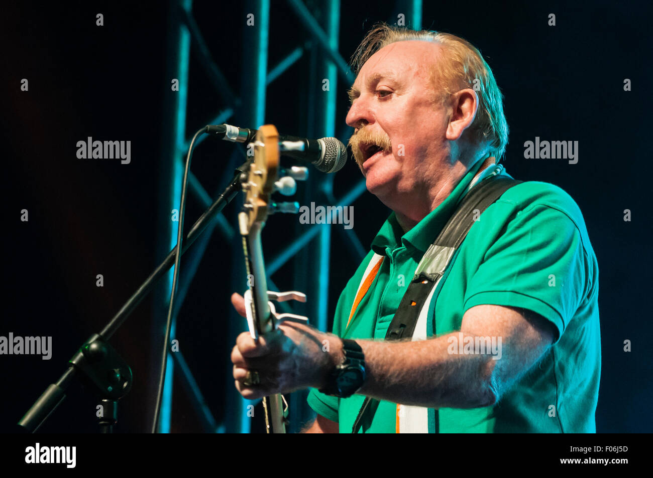 Belfast, Northern Ireland. 8 Aug 2015 - Brian Warfield from the Irish rebel band 'The Wolfe Tones' play the Feile an Phobail to an ecstatic audience. Credit:  Stephen Barnes/Alamy Live News Stock Photo