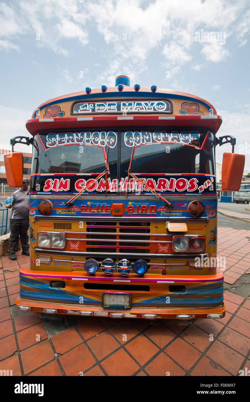 Orange typical colorful South American vintage public bus with loads of decorations on the front. Puerto La Cruz. Venezuela 2015 Stock Photo