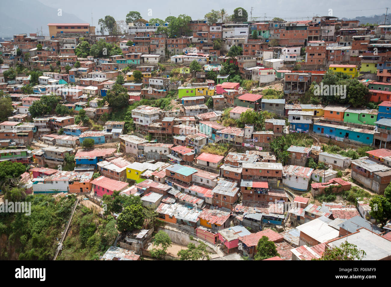 Small wooden coloured houses in the poor neighborhood in Caracas. It cover the hills around Caracas and it is dangerous Stock Photo