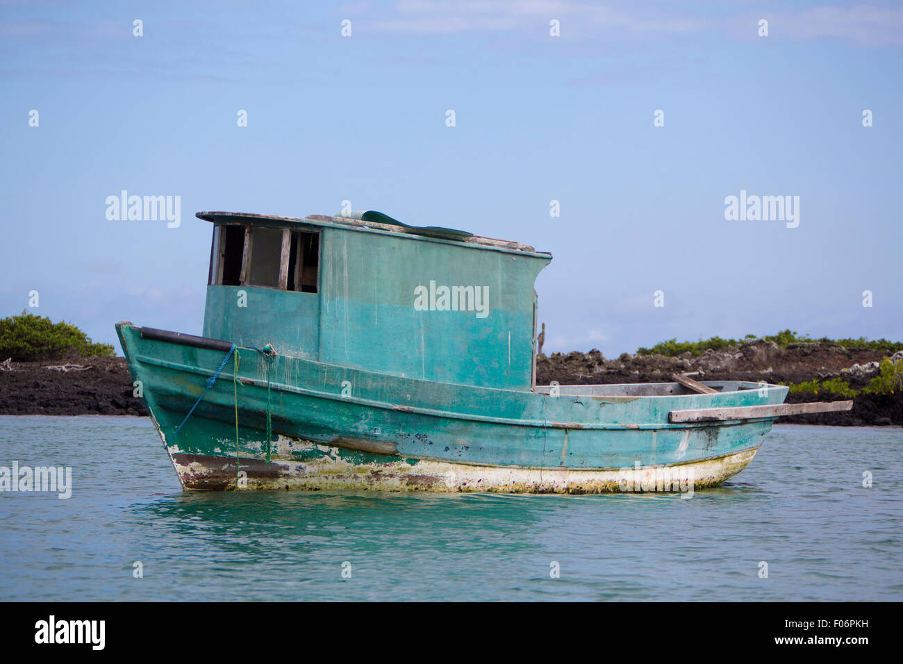 Green small fishing ship leaving the port of Puerto Ayora against a blue sky. Galapagos Islands. Ecuador 2015 Stock Photo
