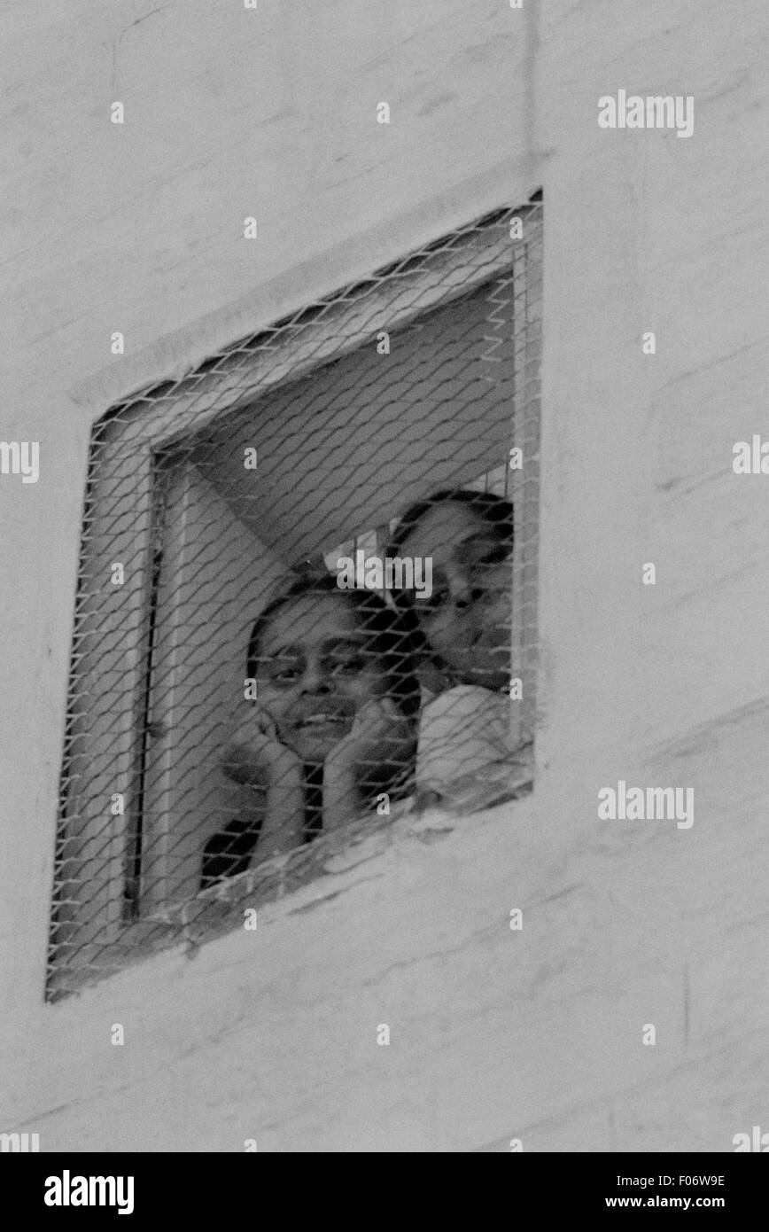 kids looking out window india brian mcguire Stock Photo