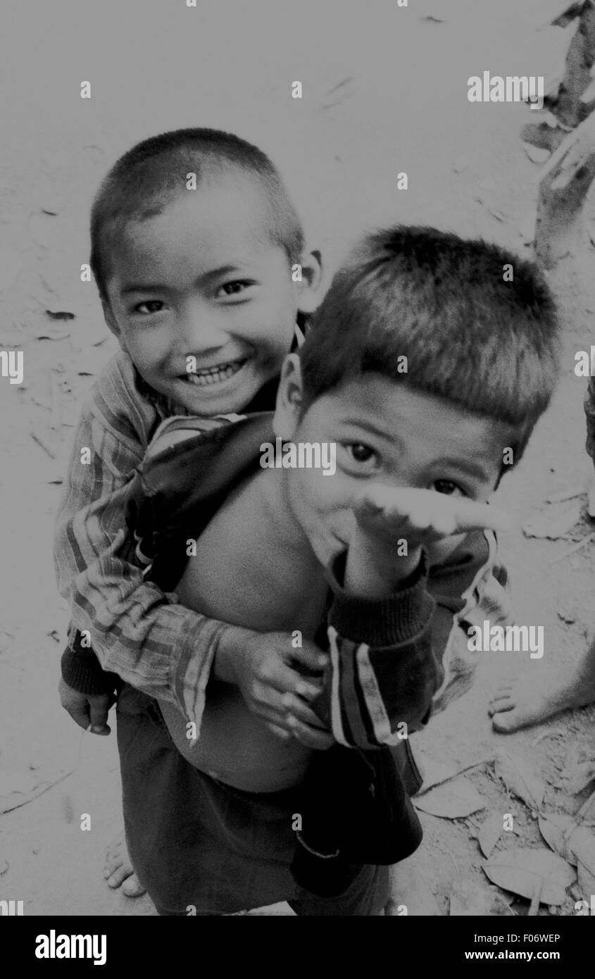street kids in myanmar playfully asking for money brian mcguire Stock Photo
