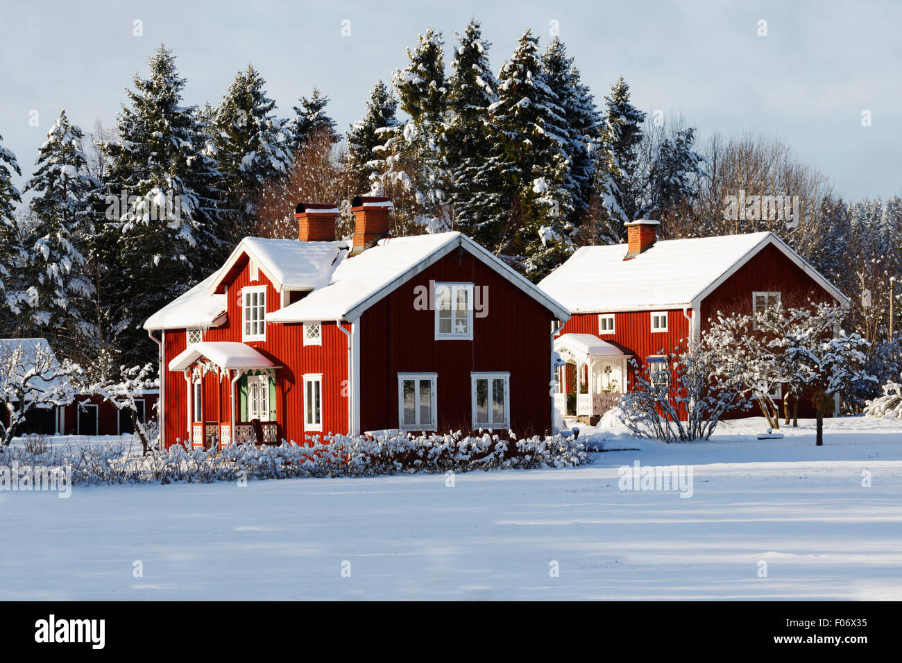 old red farms in a snowy landscape Stock Photo