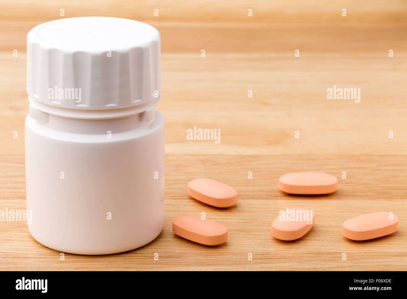 White pills bottle  on wooden table background Stock Photo