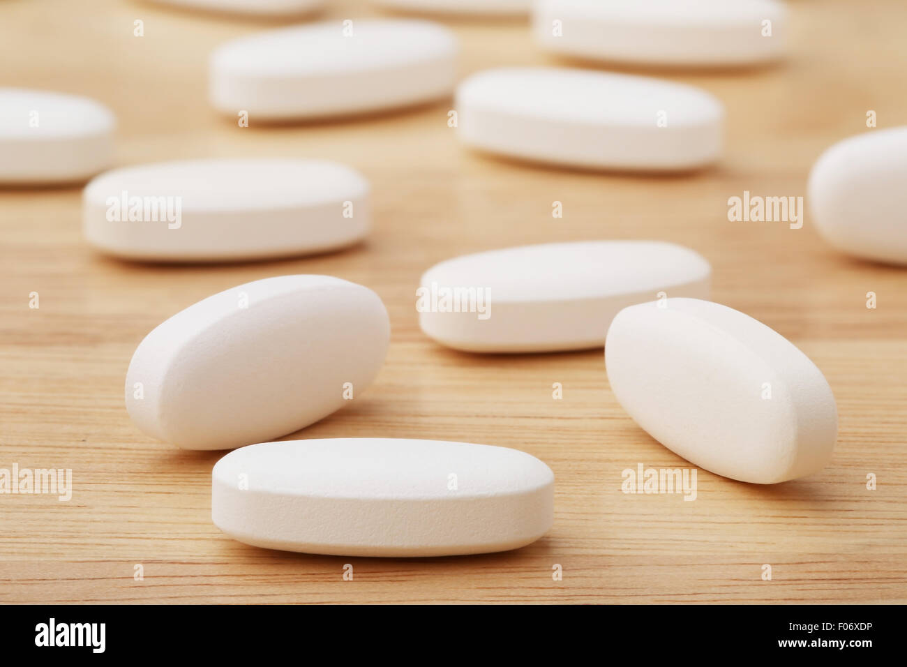 Close up white pills on wooden table background Stock Photo