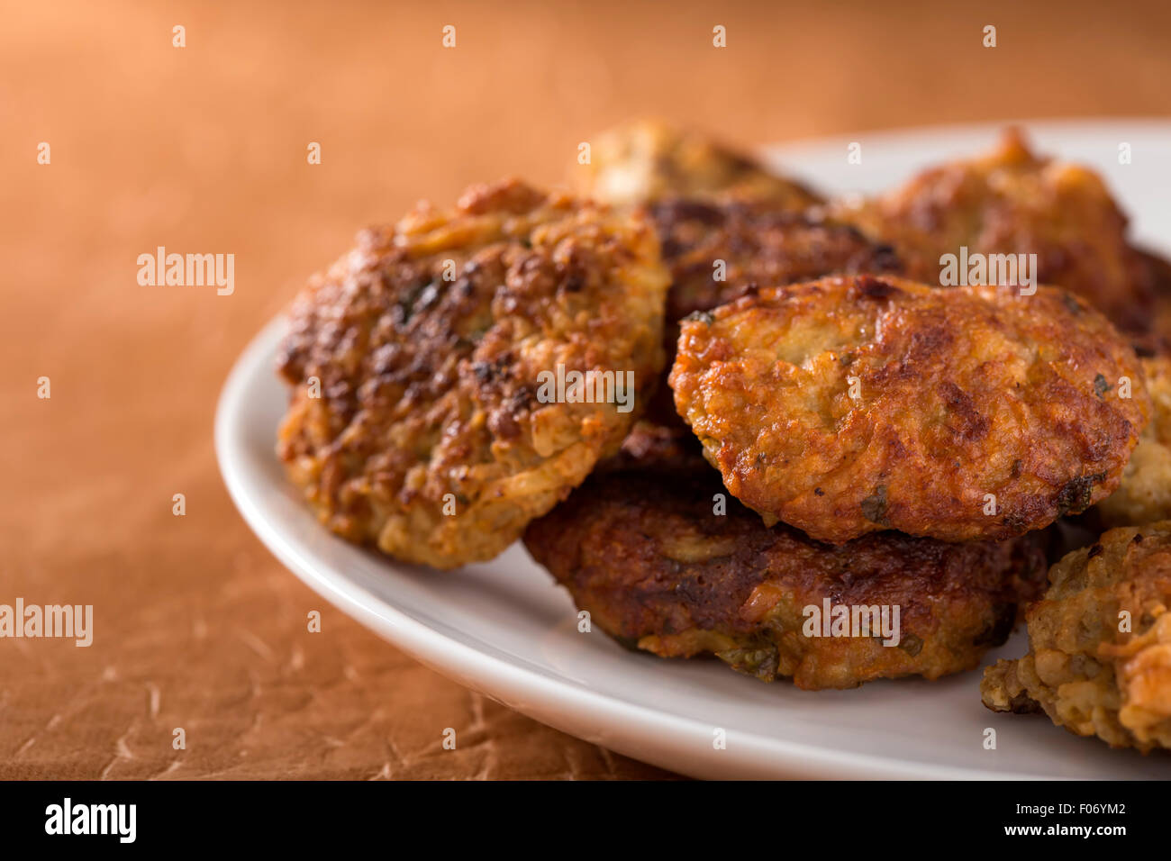 Roasted meatball on a white plate with brown background Stock Photo