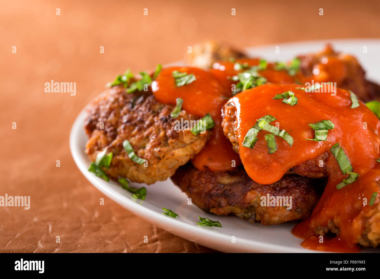 Roasted meatballs with tomato sauce in white plate Stock Photo