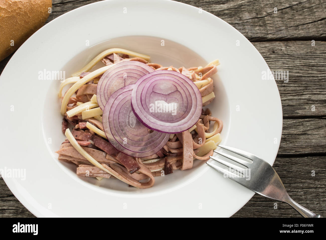 Onions on a sausage salad with ring bologna and tongue sausage Stock