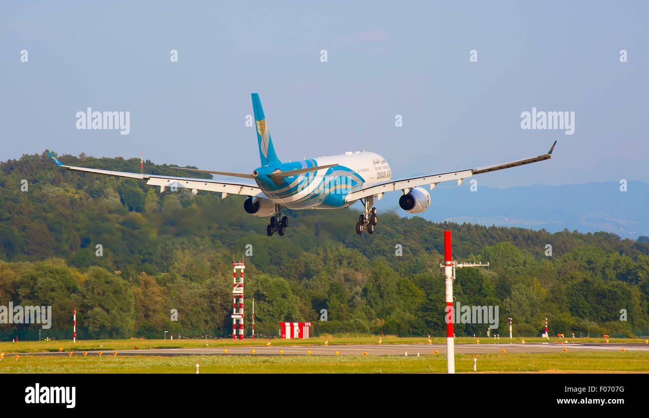 ZURICH - JULY 18: Oman Air Airbus A330 landing in Zurich airport after short haul flight on July 18, 2015 in Zurich, Switzerland Stock Photo