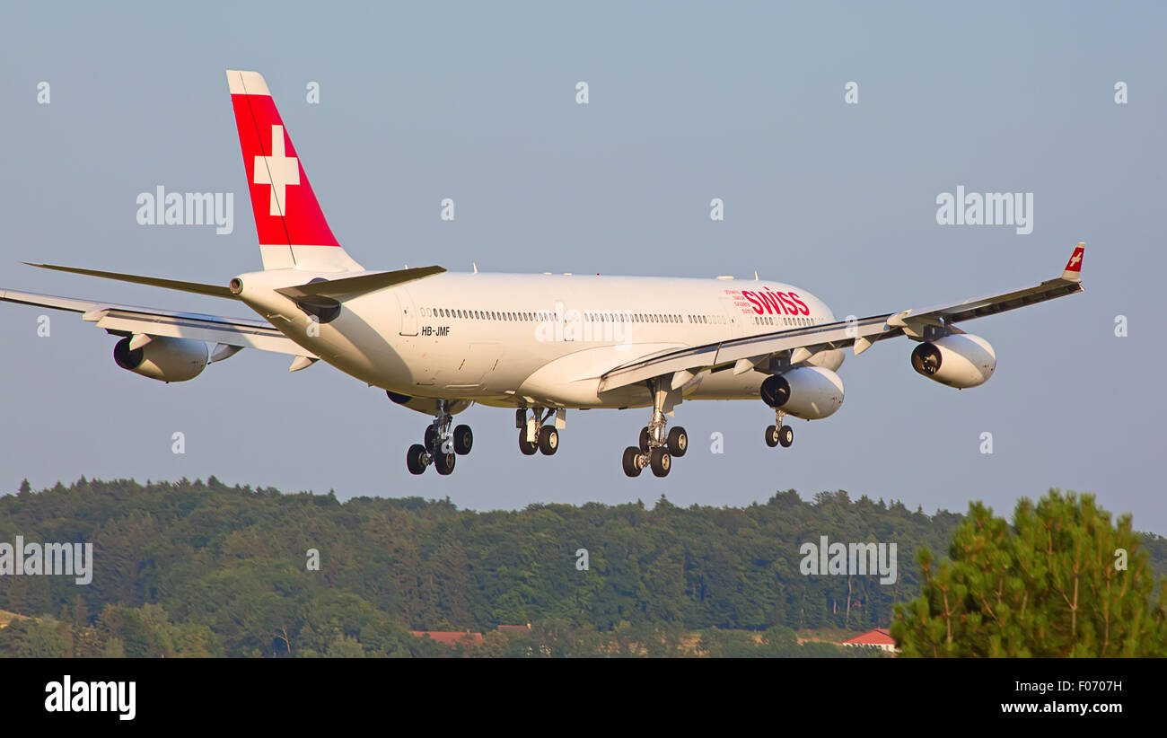 ZURICH - JULY 18: Swiss A-340 landing in Zurich airport after intercontinental flight on July 18, 2015 in Zurich, Switzerland. Z Stock Photo