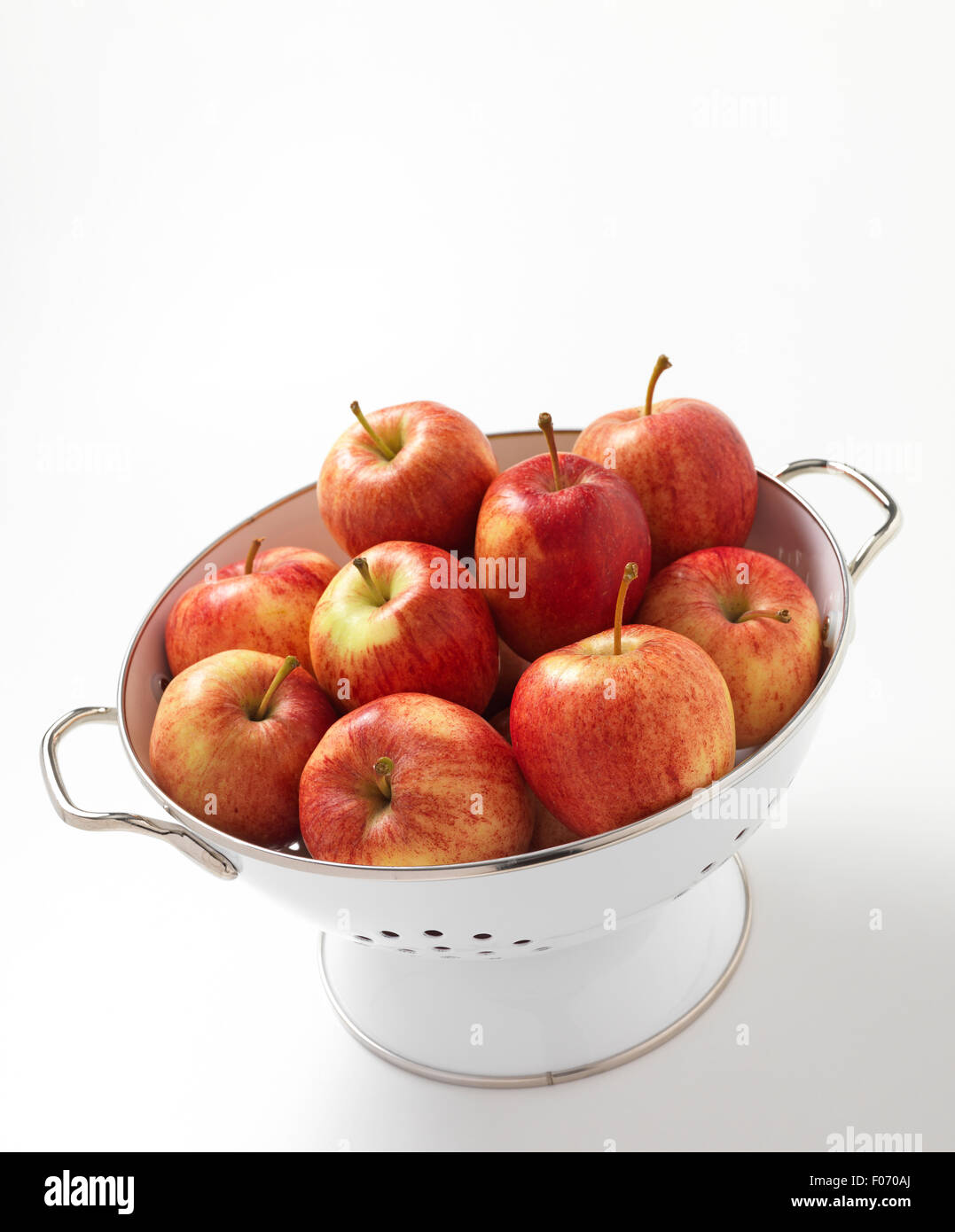 Apples isolated in a colander Stock Photo - Alamy