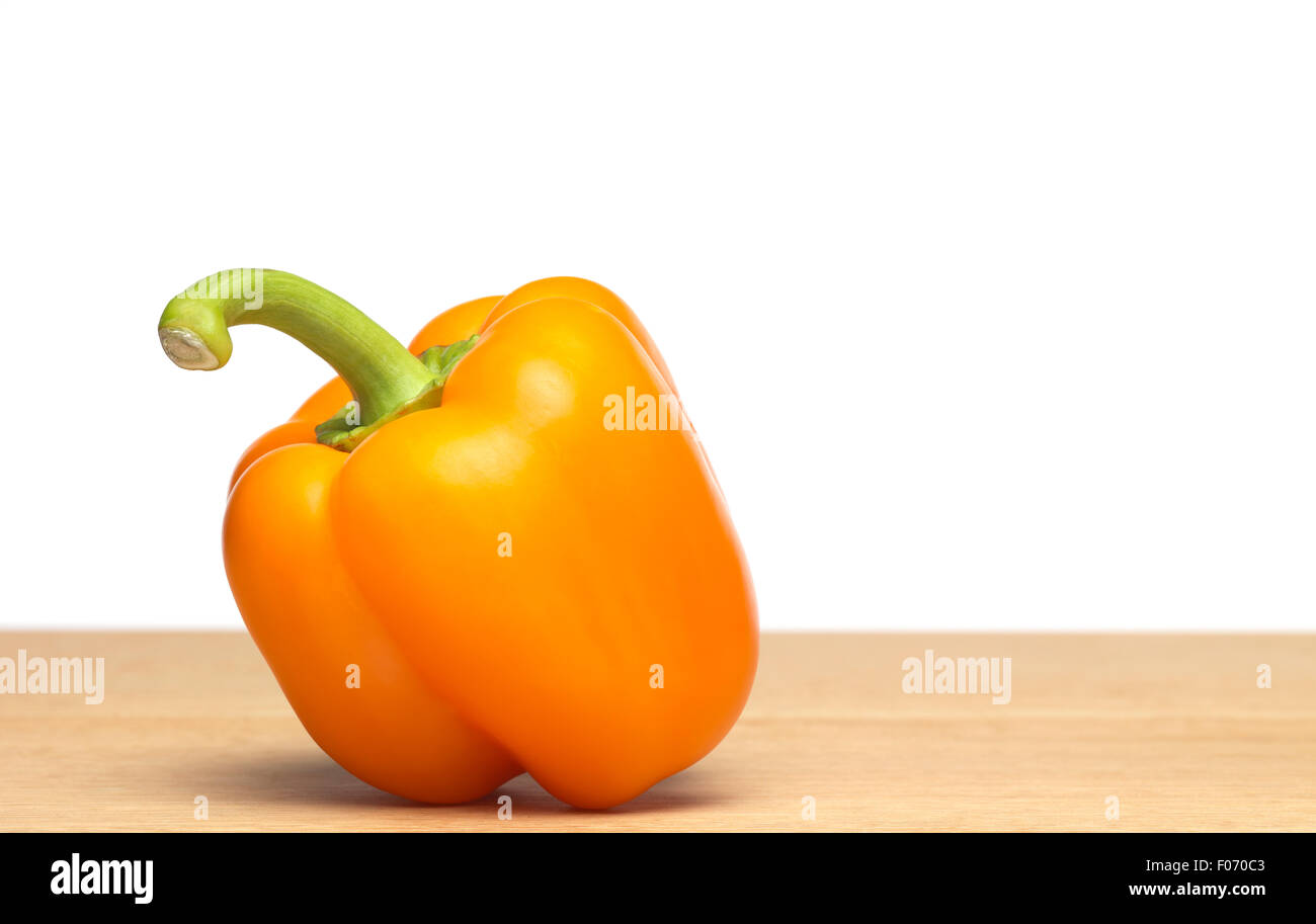 Yellow Pepper on chopping board Stock Photo - Alamy