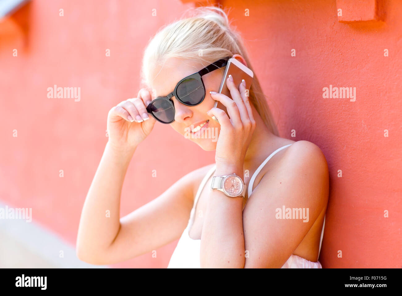 Young smiling woman talking in the phone outdoor Stock Photo