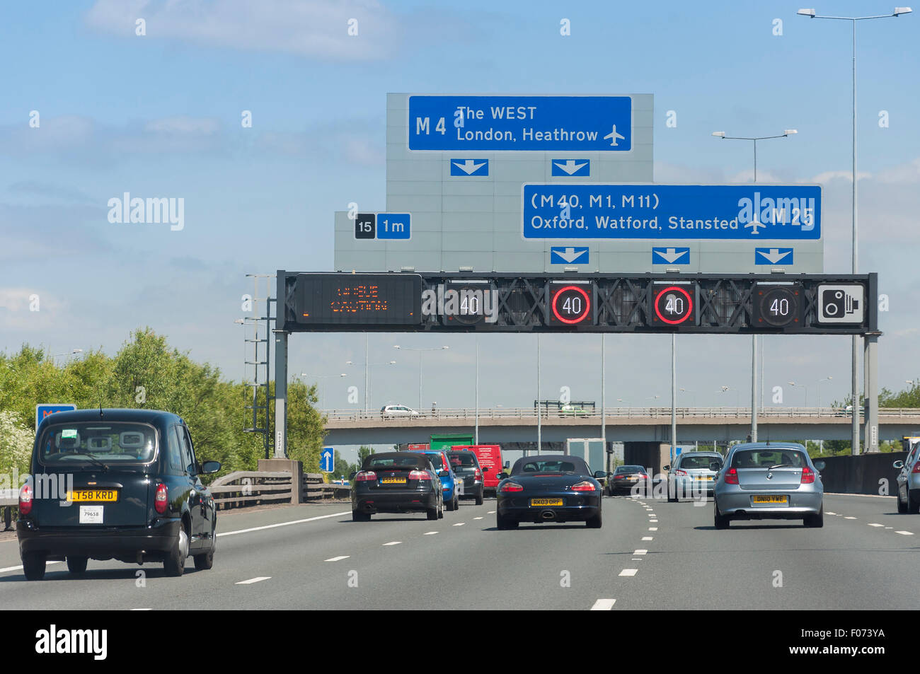 M4 Junction on M25 Motorway showing speed restrictions, Surrey, England, United Kingdom Stock Photo
