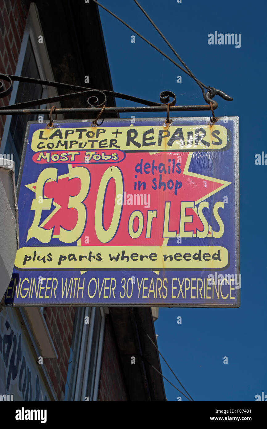 hanging sign for an independent computer repair shop, new malden, surrey, england, offering repairs for £30 or less Stock Photo