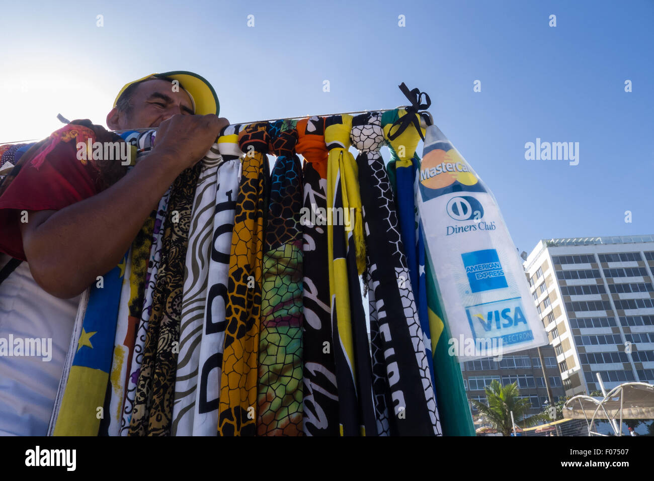 Rio de Janeiro, Brazil. Beach vendor with sarongs and credit card sign. Stock Photo