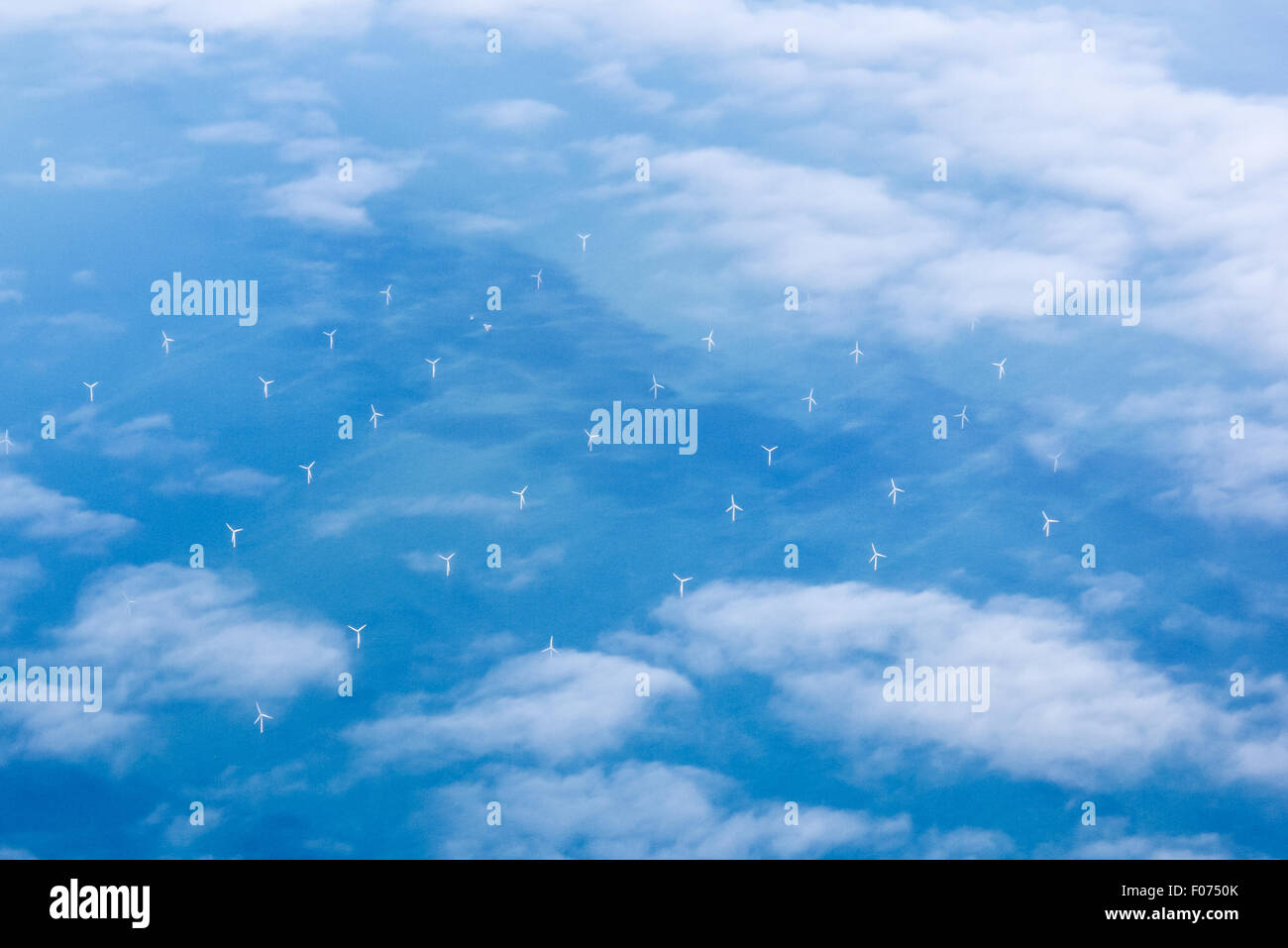 The Channel, England. Aerial view of wind turbines in the sea seen through clouds. Stock Photo