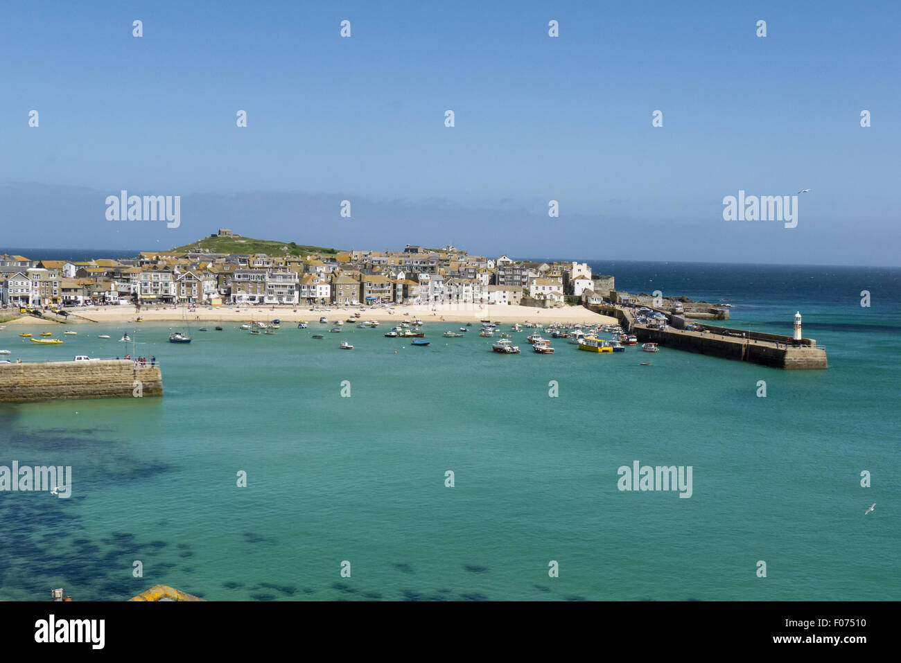 St Ives, Cornwall. Harbour lighthouse and boats. Stock Photo