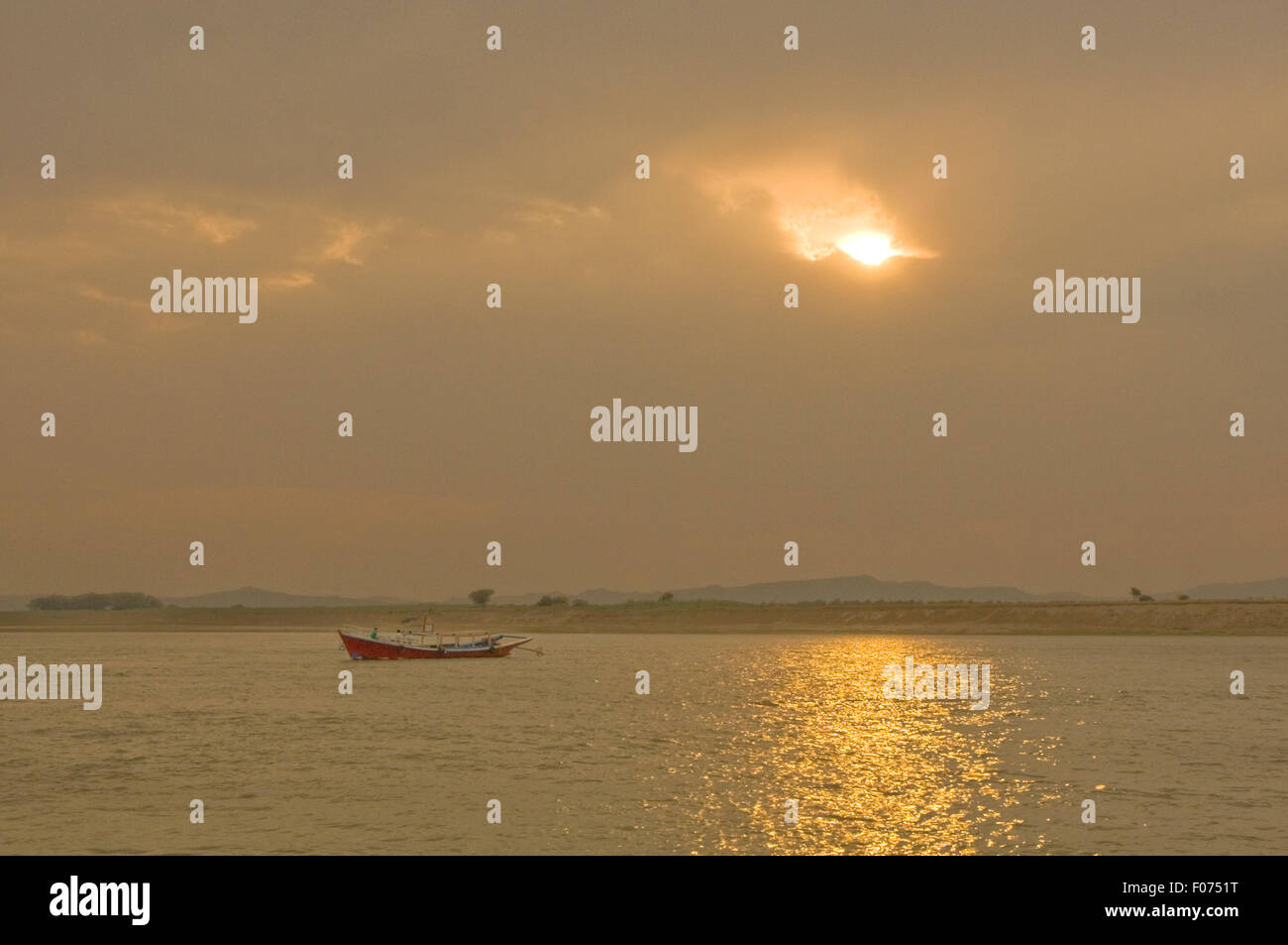 ASIA, MYANMAR (BURMA), Bagan, Irrawaddy River, ferry boat on river as sun sets Stock Photo