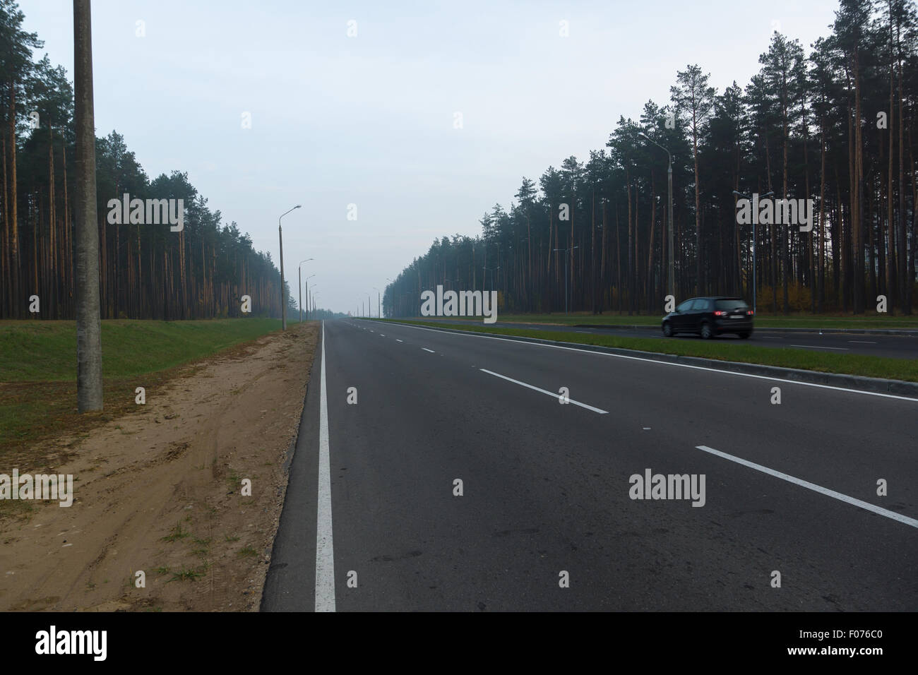the asphalted road early in the morning is shipped in fog Stock Photo ...