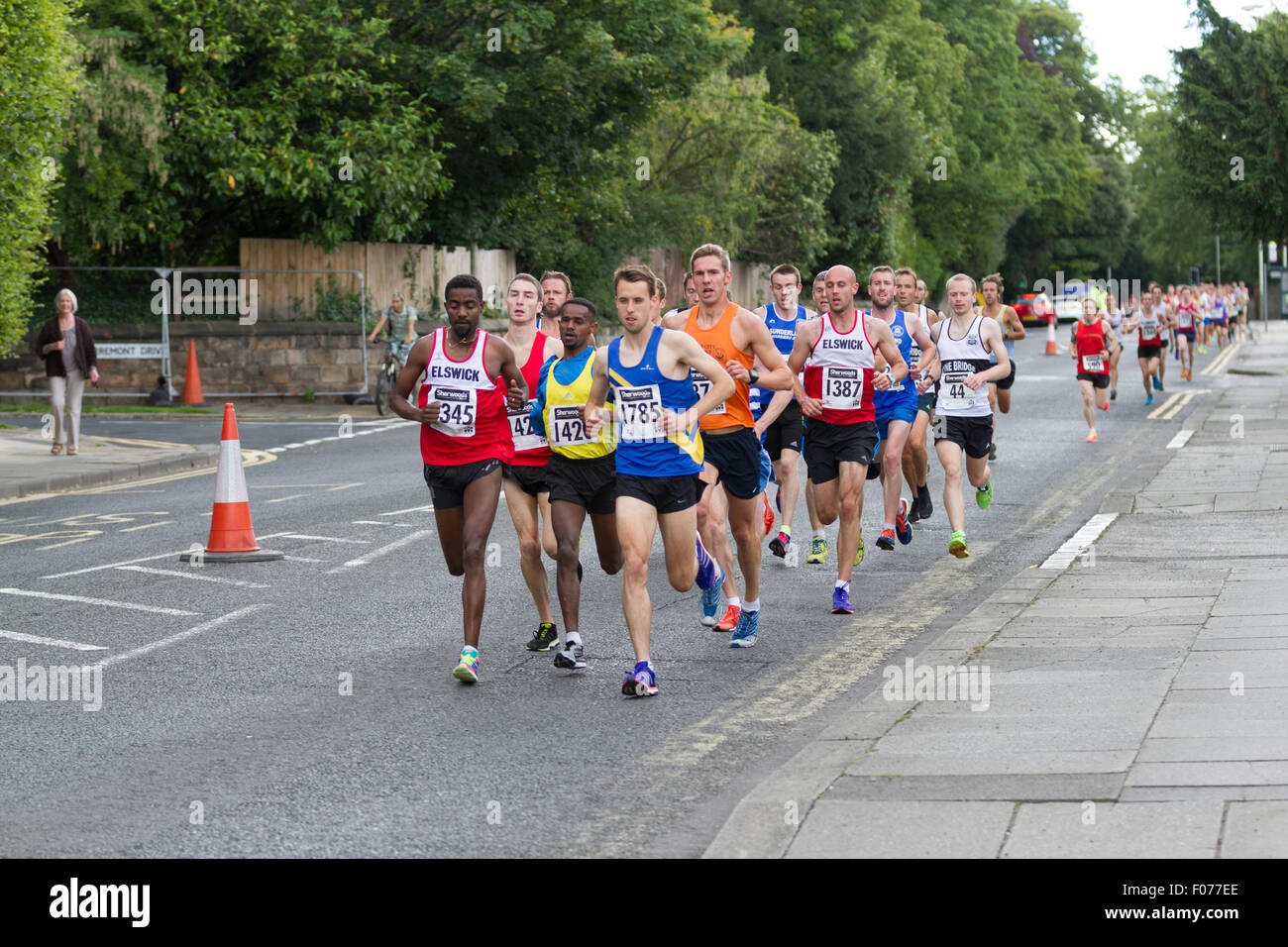 Darlington, Co. Durham, England, UK.  Sunday, 9th August, 2015.  Winners of the 28th annual Darlington 10km road race, seen here heading northwest along Woodland Road during the first of two circuits. Overall winner Marc Scott 1425, second from the left here, finished with a time of 30:42. Second place was taken by Tadele Geremew Mulugeta 1345, far left here, with 30:48, third place by Carl Smith 1785, fifth from the left here, with 30:55.  Fourth placed was Wondiye Indelbu 1420, fourth from the left here, with 31:11. Credit:  Andrew Nicholson/Alamy Live News Stock Photo