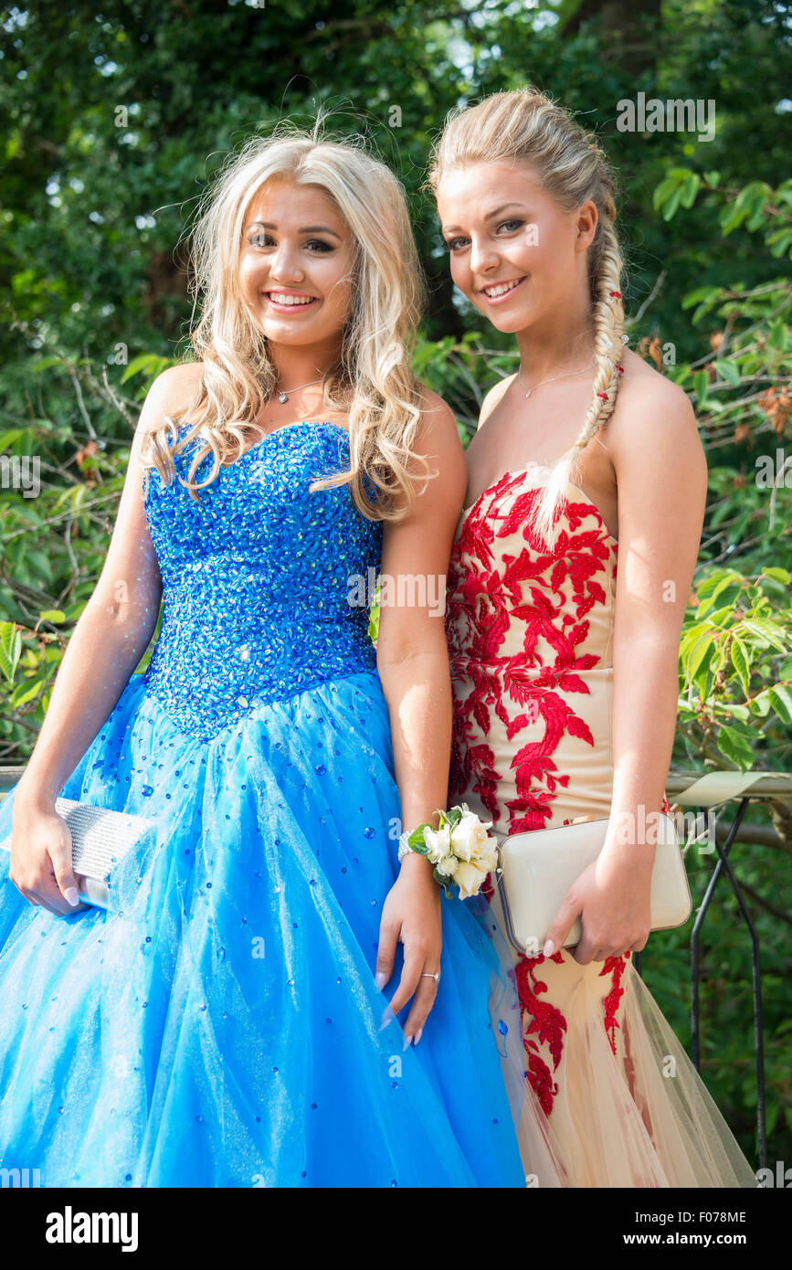 Teenage girls posing in prom dresses, Englefield Green, Surrey, England, United Kingdom Stock Photo