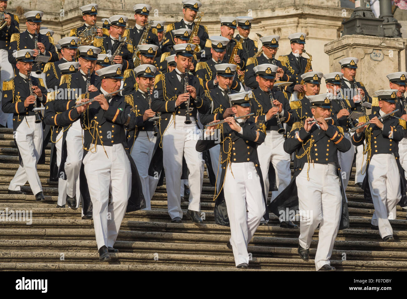 A marching band of Italian marines descends the Spanish Steps in Rome while playing their instruments. Stock Photo