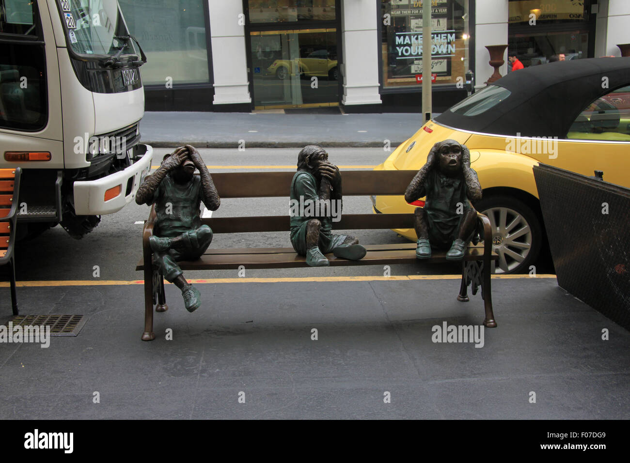 Three monkeys on a street bench - see no evil, hear no evil, do no evil Stock Photo